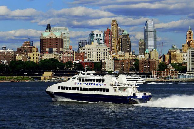 A New York Waterway ferry in the Hudson with the New Jersey skyline behind it.